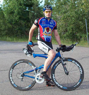 hot looking dude on high-tech road bike, training on Ile Notre-Dame's Formula 1 racing circuit in Montreal
